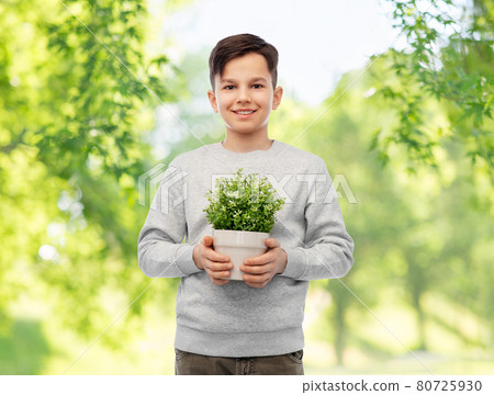 happy smiling boy holding flower in pot 80725930