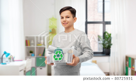 smiling boy sorting metallic waste at home smiling boy sorting metallic waste at home 80725931