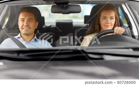 car driving school instructor teaching woman car driving school instructor teaching woman 80726000