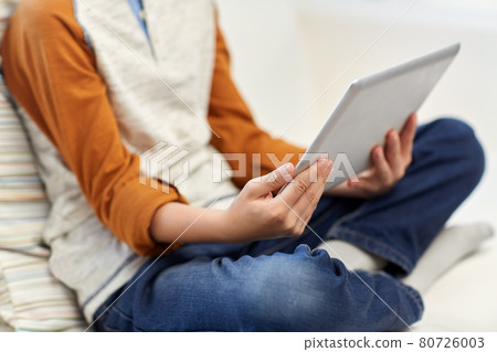 close up of boy with tablet pc computer at home close up of boy with tablet pc computer at home 80726003