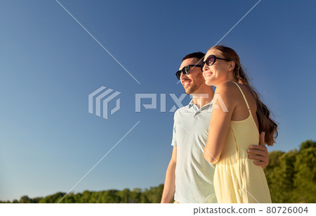 happy couple hugging outdoors in summer happy couple hugging outdoors in summer 80726004