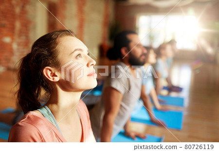 group of people doing yoga cobra pose at studio group of people doing yoga cobra pose at studio 80726119