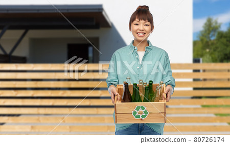 smiling young asian woman sorting glass waste 80726174