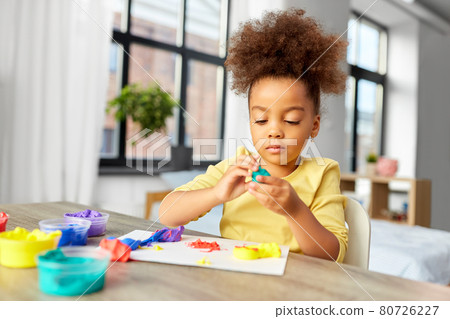 little girl with modeling clay playing at home little girl with modeling clay playing at home 80726227
