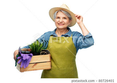 smiling senior woman with garden tools in box smiling senior woman with garden tools in box 80726401