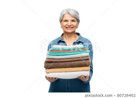 smiling senior woman with clean bath towels smiling senior woman with clean bath towels 80726402