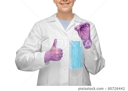 female doctor with medical mask showing thumbs up female doctor with medical mask showing thumbs up 80726442