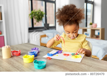little girl with modeling clay playing at home little girl with modeling clay playing at home 80726470