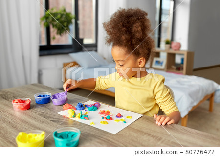 little girl with modeling clay playing at home little girl with modeling clay playing at home 80726472