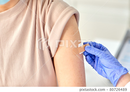close up of doctor attaching patch to patient close up of doctor attaching patch to patient 80726489
