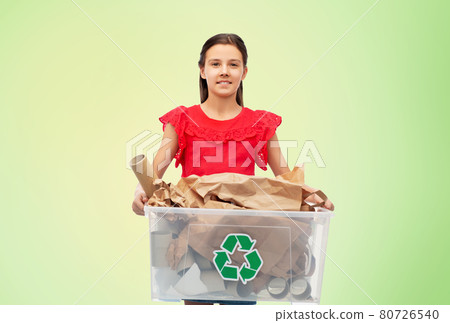 smiling girl sorting paper waste over green 80726540