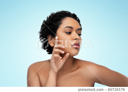 young african american woman with moisturizer young african american woman with moisturizer 80726576
