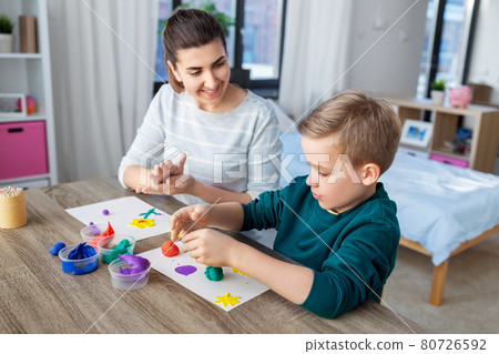 mother and son playing with modeling clay at home mother and son playing with modeling clay at home 80726592