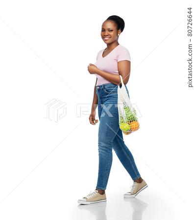african woman with food in reusable string bag 80726644