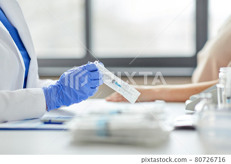 female doctor with syringe and patient at hospital 80726716