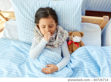 sick coughing girl with teddy bear lying in bed sick coughing girl with teddy bear lying in bed 80726718