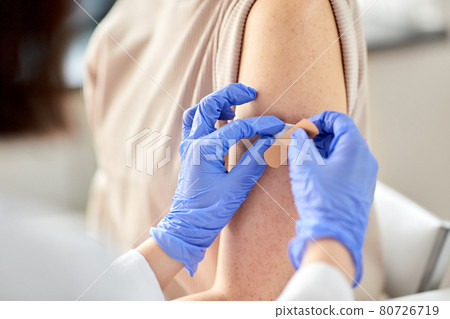 close up of doctor attaching patch to patient close up of doctor attaching patch to patient 80726719