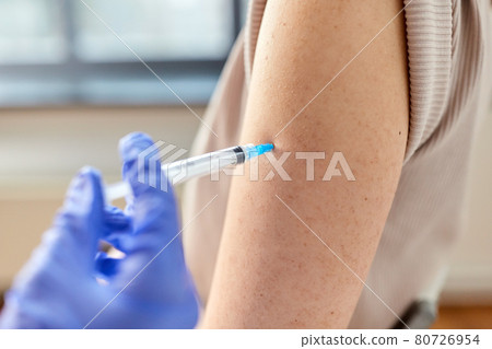 close up of hand with syringe vaccinating patient close up of hand with syringe vaccinating patient 80726954