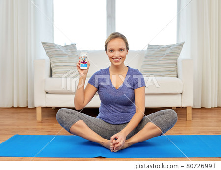 woman with smartphone having online yoga class 80726991