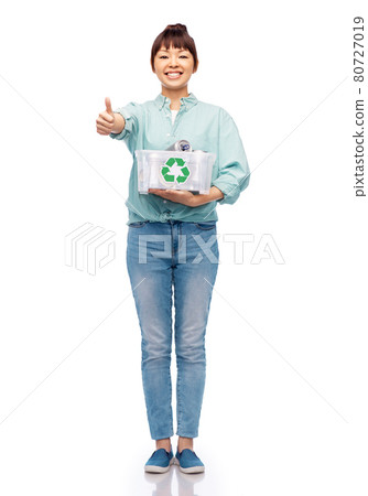 smiling young asian woman sorting metallic waste smiling young asian woman sorting metallic waste 80727019