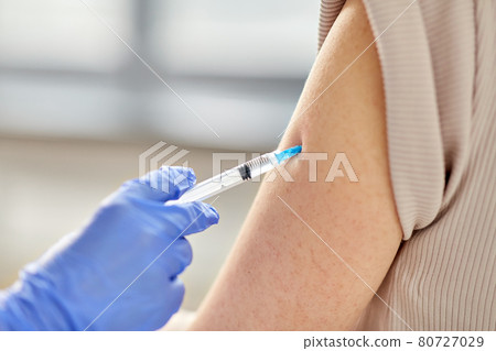 close up of hand with syringe vaccinating patient close up of hand with syringe vaccinating patient 80727029