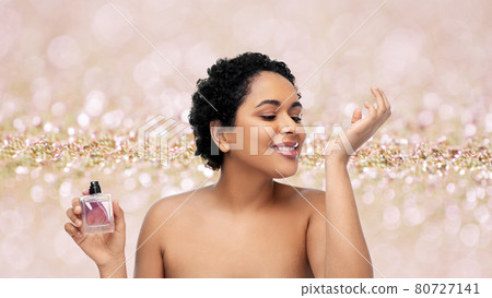 young african american woman with perfume young african american woman with perfume 80727141