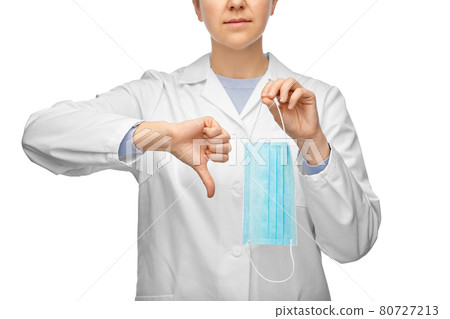 female doctor with mask showing thumbs down female doctor with mask showing thumbs down 80727213