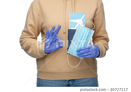 woman with mask, passport and ticket shows ok sign woman with mask, passport and ticket shows ok sign 80727217