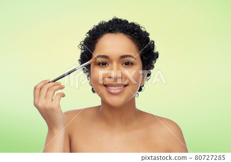 african american woman with make up brush african american woman with make up brush 80727285
