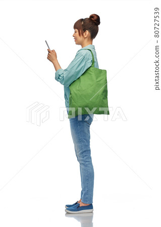 woman with phone and reusable food shopping bag woman with phone and reusable food shopping bag 80727539