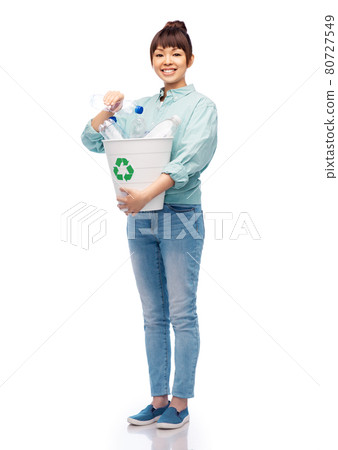 smiling young woman sorting plastic waste smiling young woman sorting plastic waste 80727549