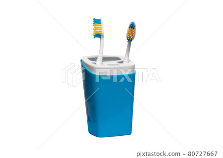 Two toothbrushes in glass isolated on white Two toothbrushes in glass isolated on white 80727667