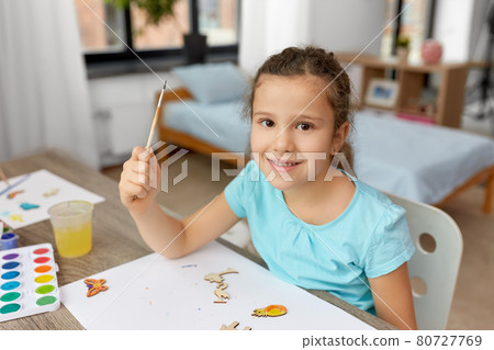 little girl painting wooden items at home little girl painting wooden items at home 80727769