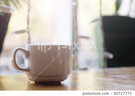 White cup of coffee on n table on window background White cup of coffee on n table on window background 80727775