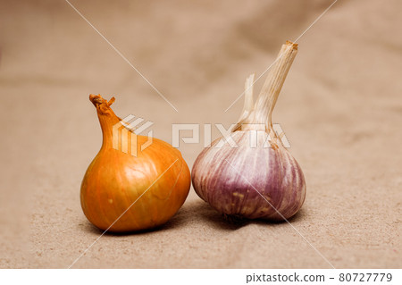 Bulbs and garlic on a background of burlap cloth Bulbs and garlic on a background of burlap cloth 80727779