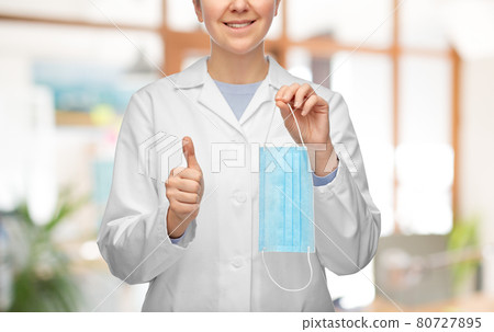 female doctor with medical mask showing thumbs up 80727895