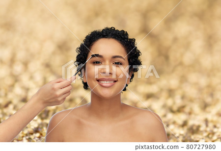 happy woman and hand of make up artist with brush happy woman and hand of make up artist with brush 80727980