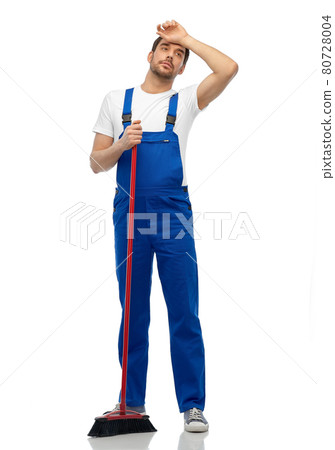 tired male cleaner cleaning floor with broom 80728004