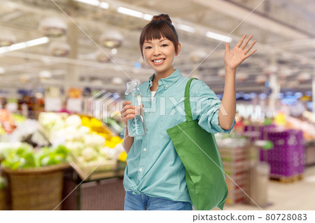 woman with bag for food shopping and glass bottle woman with bag for food shopping and glass bottle 80728083