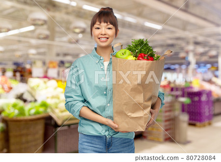 happy asian woman with food in paper shopping bag happy asian woman with food in paper shopping bag 80728084