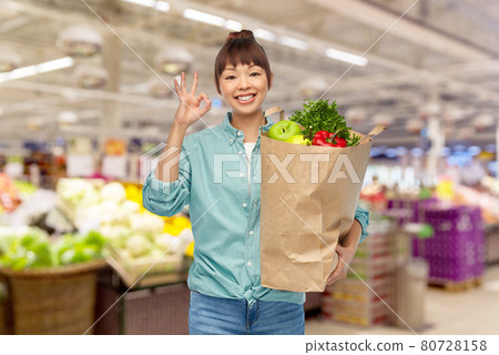 happy asian woman with food in paper shopping bag happy asian woman with food in paper shopping bag 80728158