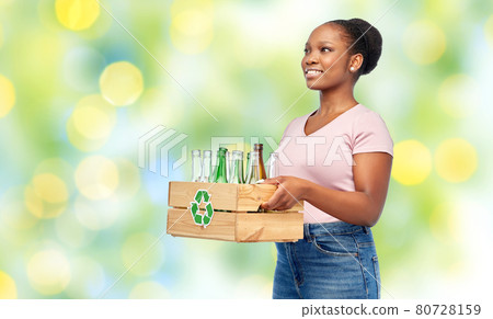 happy african american woman sorting glass waste happy african american woman sorting glass waste 80728159