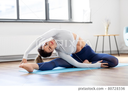young woman doing yoga exercise at home 80728336
