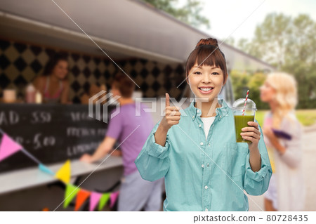 happy asian woman with juice over food truck 80728435