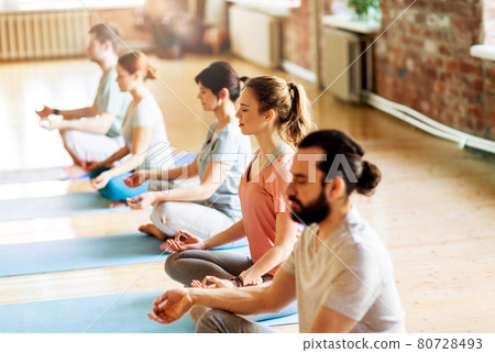 group of people making yoga exercises at studio 80728493