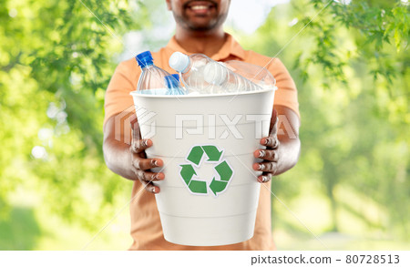 close up of young indian man sorting plastic waste 80728513