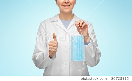 female doctor with medical mask showing thumbs up 80728515