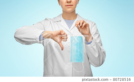 female doctor with mask showing thumbs down female doctor with mask showing thumbs down 80728516