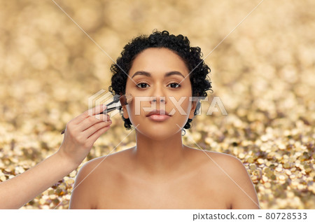 woman and hand of make up artist with brush woman and hand of make up artist with brush 80728533
