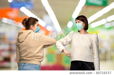 women in masks making elbow bump greeting gesture women in masks making elbow bump greeting gesture 80728537
